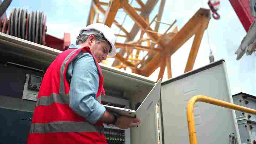 electrical-engineer-inspects-electrical-control-board-crane-before-putting-it_11zon